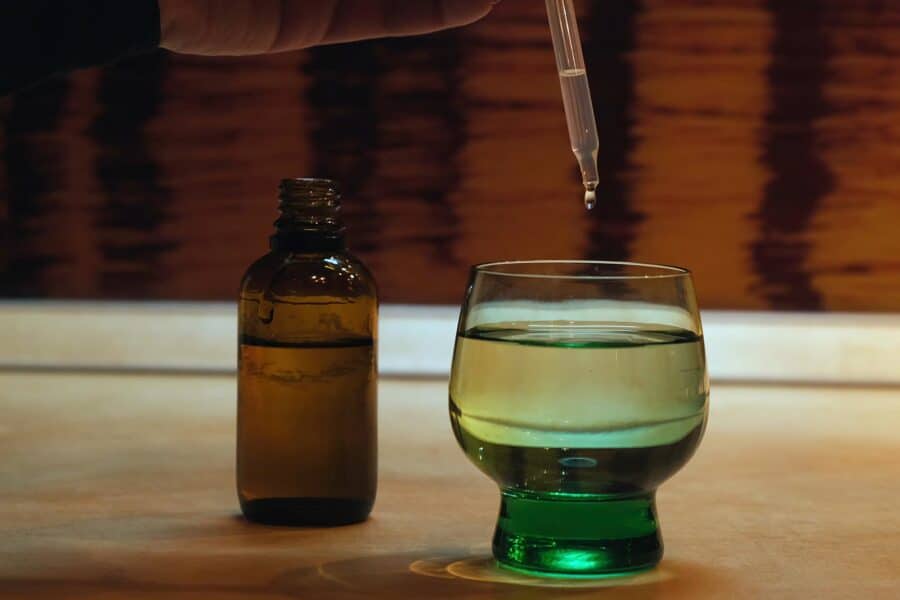 How Long Does Lean Stay In Your System? A dropper of a liquid being added to a drink.